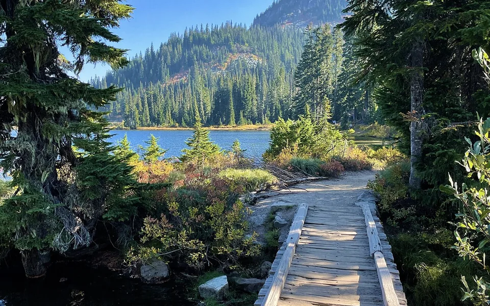 A wooden path beside a mountain lake